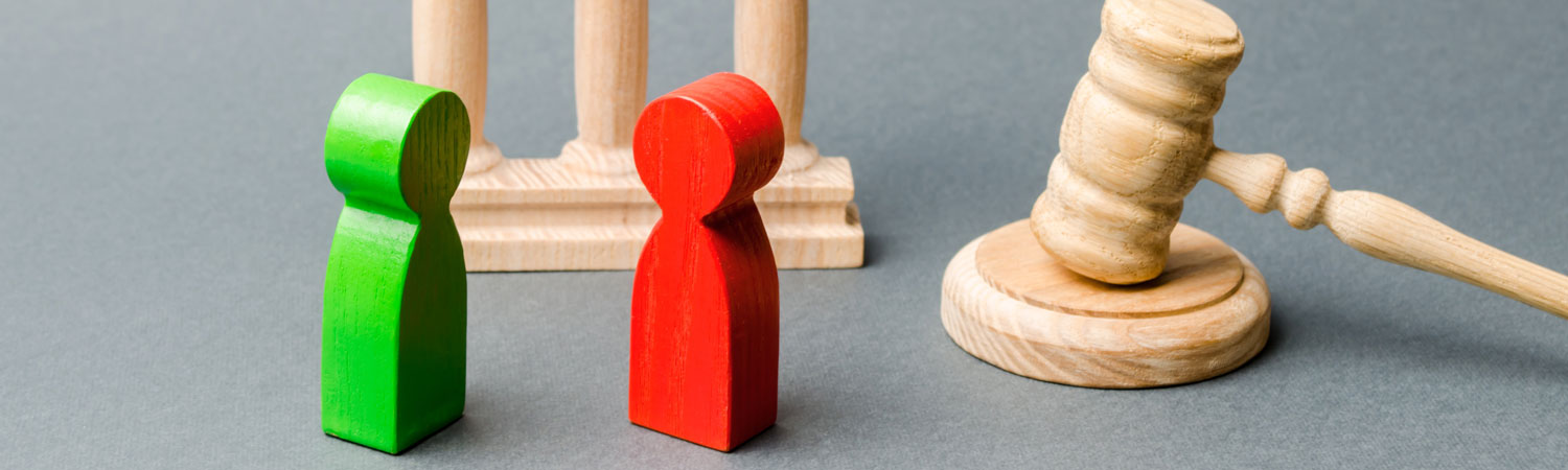 Wooden Figures Of People Standing Near The Judge S